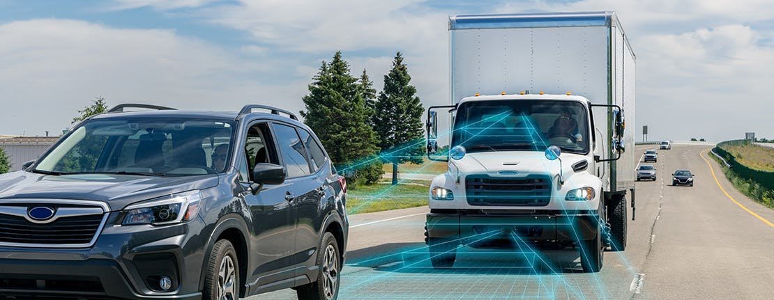 A truck with stylized radar lines extending from the front to showcase how Detroit Assurance's tailgate warning detects moving vehicles in front of them.